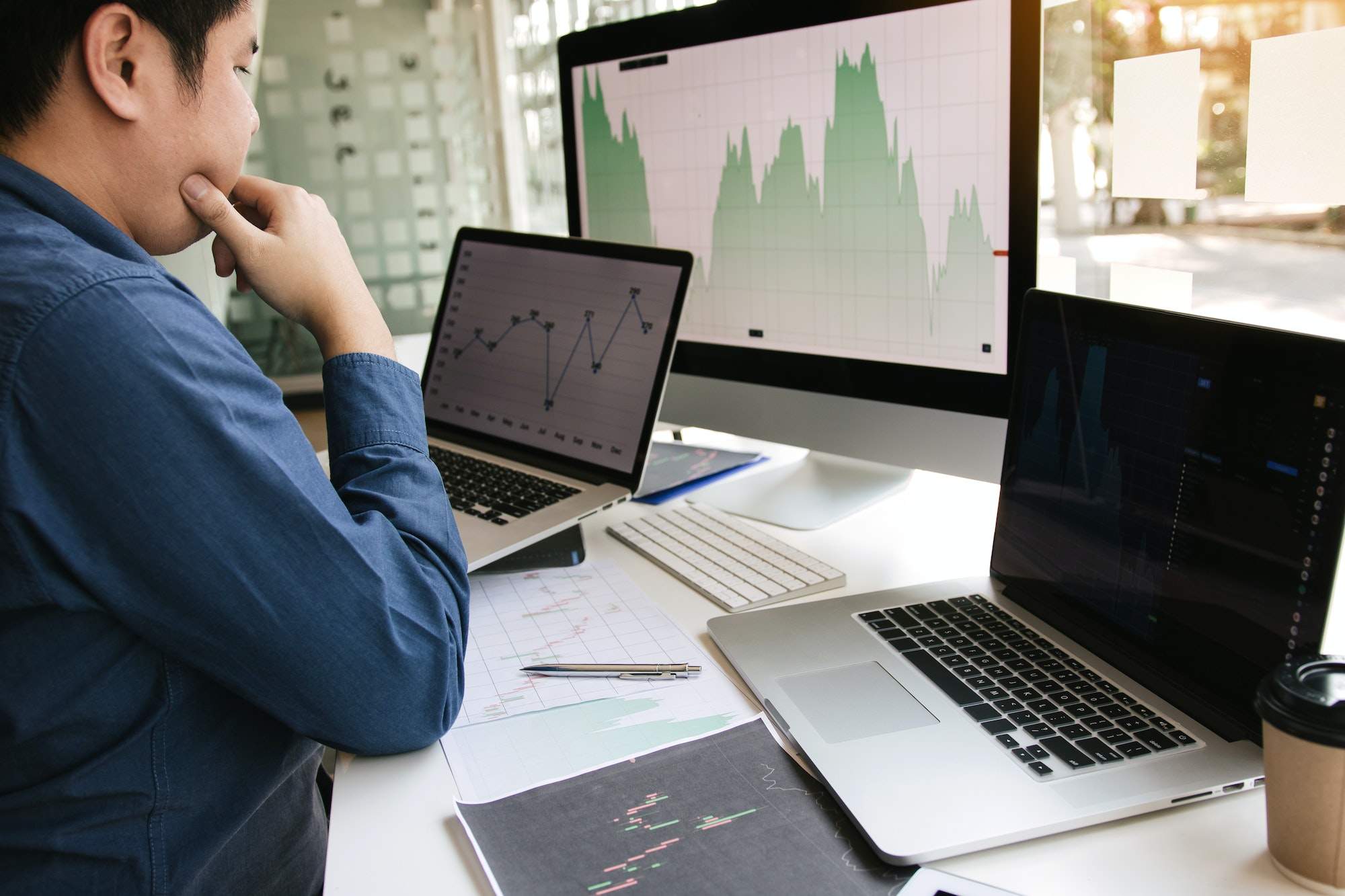 Investors are using laptops entering investment websites stocks market and partners