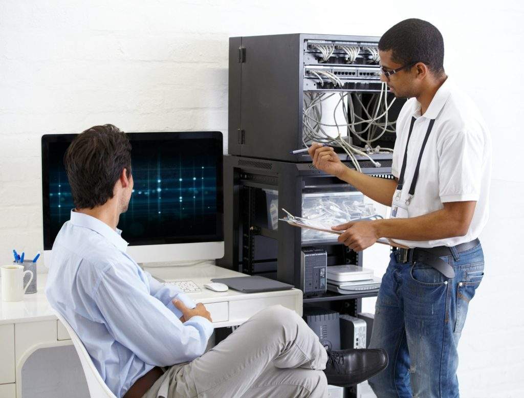 Onsite IT support. A young IT specialist ready to fix a server.